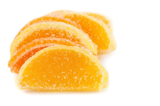 slices of orange and jelly candies isolated on white background