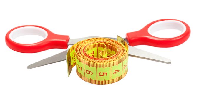 Measuring tape and scissors of the tailor isolated over white background