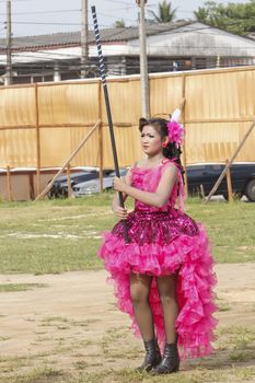 THAILAND - JULY 13: Miss Pirada Suwannarak Drum Major leads holding mace during Dokbual game school parade on July 13, 2012 in Suratthanee, Thailand.