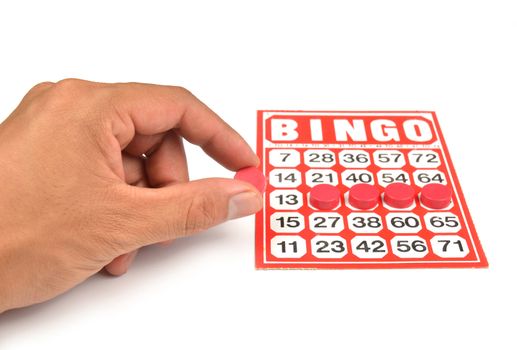bingo card with hand hold winning chips 
