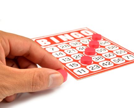 bingo card with hand hold winning chips 