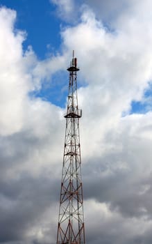 telecommunications tower on background sky cloud