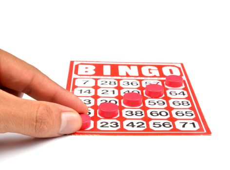 bingo card with hand hold winning chips 