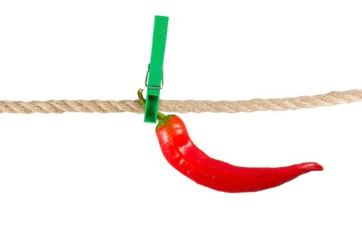 red pepper chile on clothes-peg rope isolated on white background.