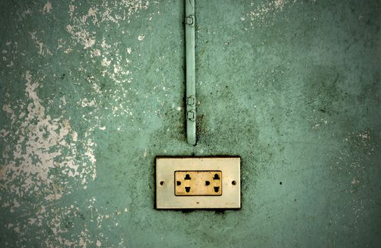 electric outlet in a wall in an old house interior 