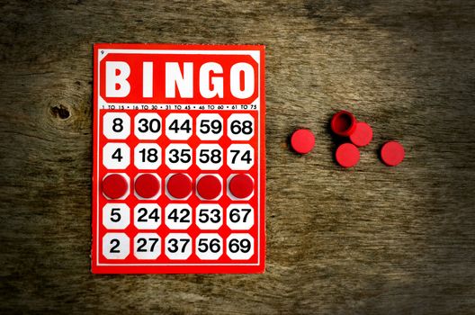 Red bingo card with winning chips 
