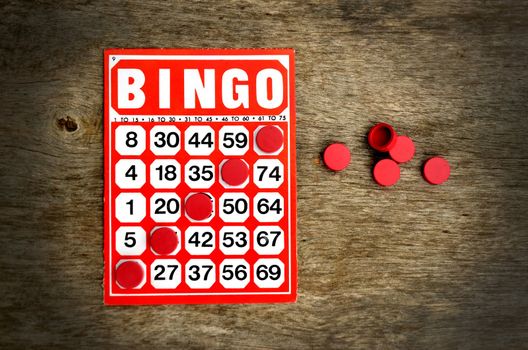 Red bingo card with winning chips 