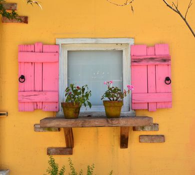 old open window and yellow wall