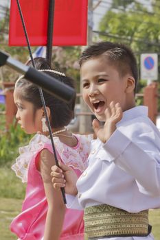 THAILAND - JULY 13: Thai students holding flag in Dokbual game school parade on July 13, 2012 in Suratthanee, Thailand.