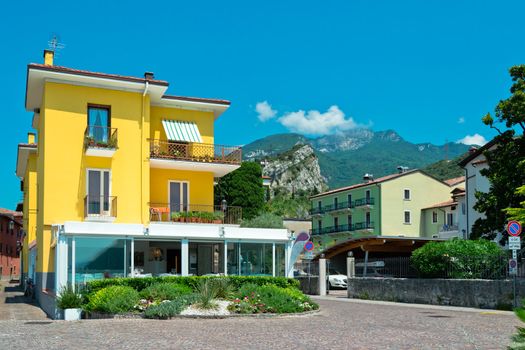 Small yellow suburb house with beautiful mountains on background
