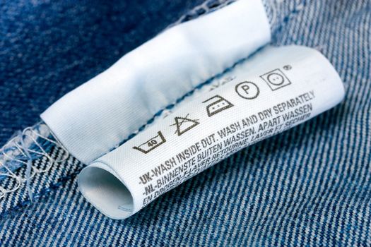 Laundry advice care symbols description , jeans blue background