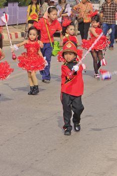 CHIYA, SURATTHANEE - JULY 13 : The unidentified Thai school children Drum Major leads holding mace during Dokbual game school parade on July 13, 2012 at Chiya, Surathanee, Thailand.