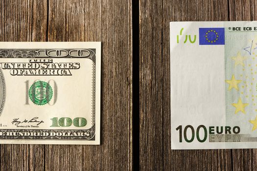 US and euro currency over wooden background