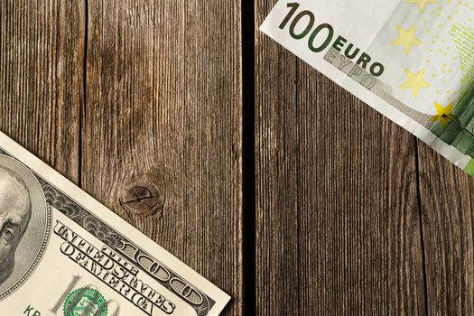 US and euro currency over wooden background