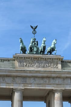 Brandenburg Gate Quadriga (German: Brandenburger Tor), former city gate, landmarks of Germany, on blue sky background