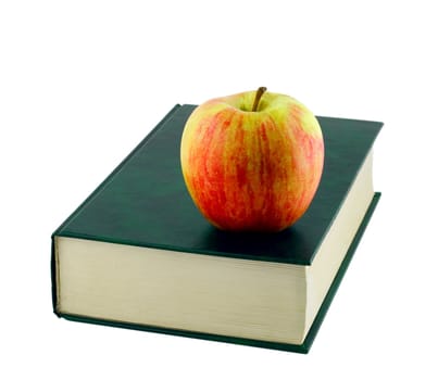 Apple on book isolated on white background