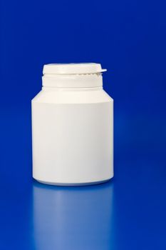 white plastic medicine container isolated on blue background