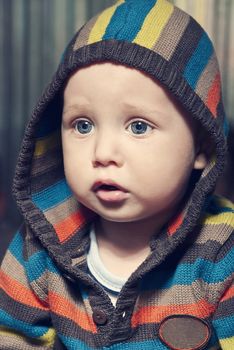 Closeup portrait of adorable child in hood.