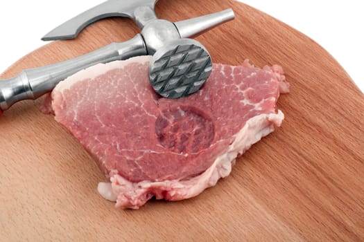 meat cleaver in fresh pork chops isolated on white background
