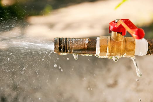 The jet spray of water from a water tap.