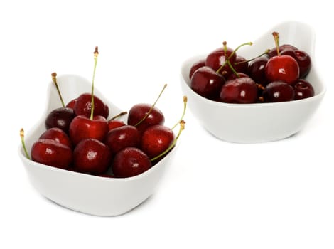 Fresh Ripe Perfect Sweet Cherry in two white bowls isolated on white background