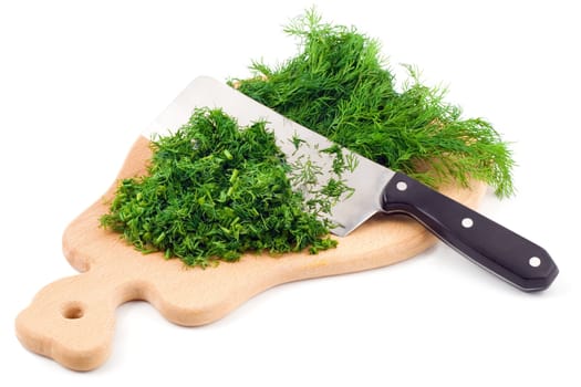Cutting fresh dill on a cutting board isolated on white