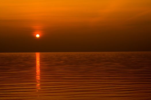 sundown scene with dark clouds and rays over sea. background, wallpaper.