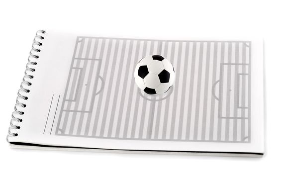 soccer field with ball in spiral note pad , isolated on white background