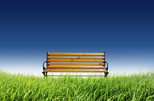 Outdoor: bench chair in the grassland with blue sky in the background