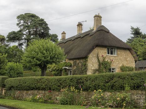 Beautiful old cottage with thatched roof in the village of Chipping Campden, Cotswold, United Kingdom.