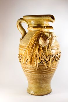 Pottery pitcher antique ,in brown background.
