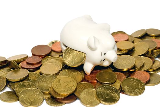 piggy bank on stacks of coins isolated on white background