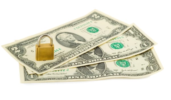 padlock in stack of american dollars isolated on white