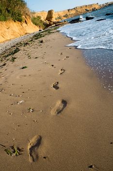 Foot steps in sand beach