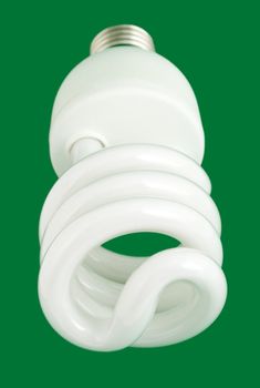 compact fluorescent light bulb close-up , isolated on green background