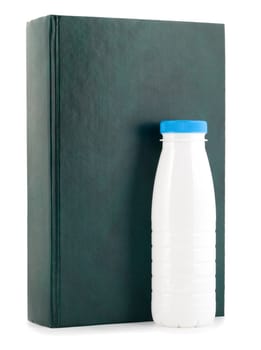 book and milk bottle close-up isolated on white background