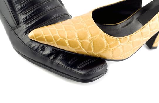 Black male shoe and yellow female shoe isolated on white