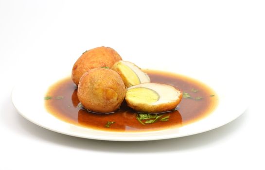 boiled egg fried with tamarind sauce on white background