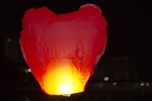 Flying small lamp in the night sky