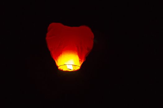 Flying small lamp in the night sky