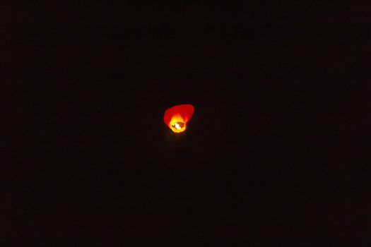 Flying small lamp in the night sky