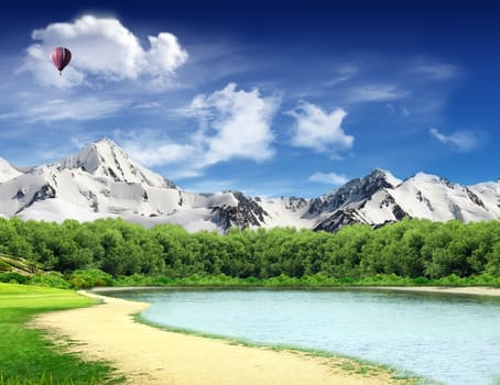 Landscape with lake, woods and mountains with snow and glaciers and hot air balloon flying in the sky