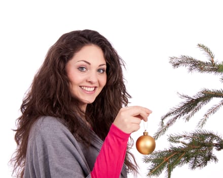 beautiful brunette woman is decorating a christmas tree isolated on white