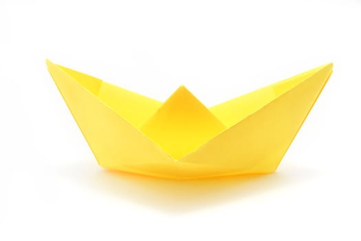 View of yellow paper ship over white background