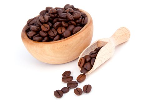 coffee beans in the wooden spoon, isolated on white background
