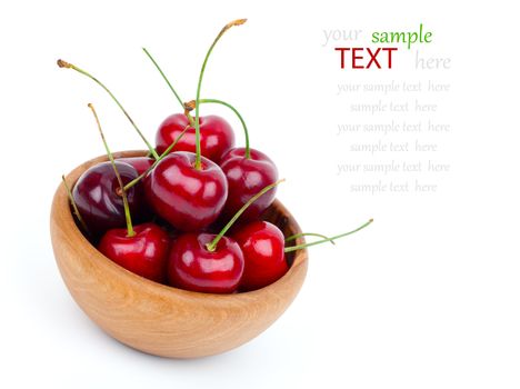 Cherry in wooden bowl isolated on white background