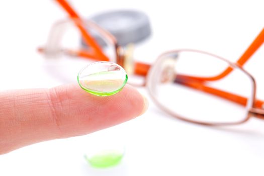 Contact lens on finger,  isolated on white background