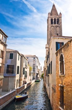 Nice venetian canal and catholic church, Venice, Italy