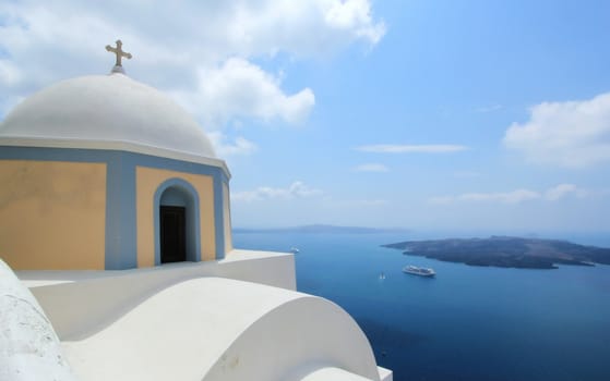 Dome and cross of a greek orthodox church in Santorini island, Greece, by beautiful weather