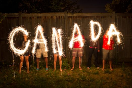 The word Canada in sparklers in time lapse photography as part of Canada Day (July 1) celebration.